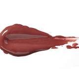 Truffle 100% Pure Lip Caramel swatch: thick, glossy deep mauve-brown liquid lipstick spread into an elongated smear, with raised ridges and a tapering streak at one end.