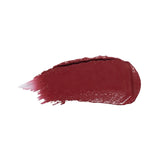 A horizontal swatch of Black Rose lipstick in deep burgundy, with a glossy surface and fine brush marks fading from one end.