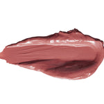 A thick smear of Buttercup lipstick in muted mauve pink, with a smooth glossy centre, raised creamy edges and a tapered end on white.