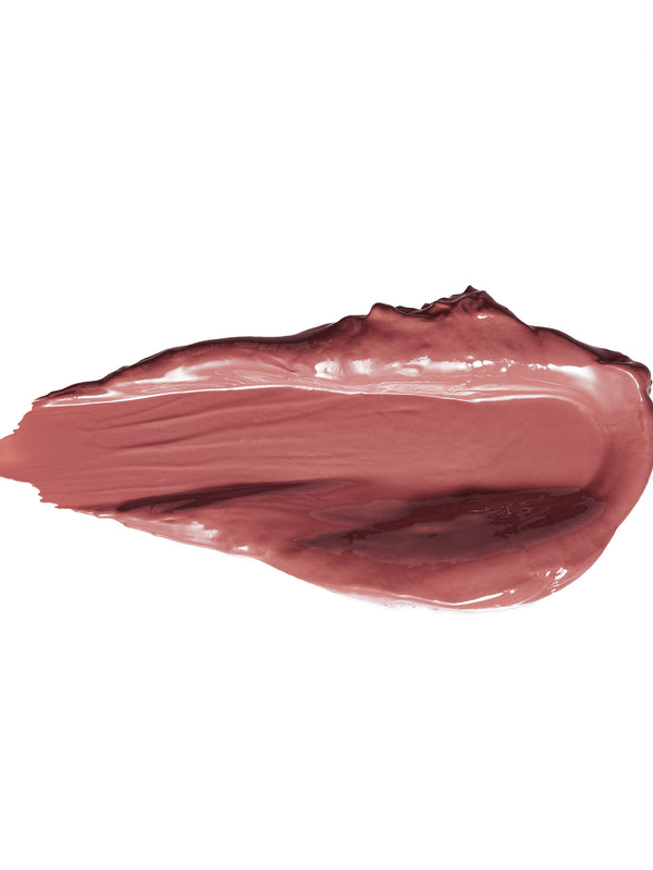 A thick smear of Buttercup lipstick in muted mauve pink, with a smooth glossy centre, raised creamy edges and a tapered end on white.