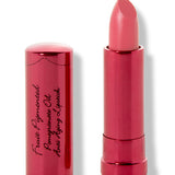 Magnolia lipstick with a slanted bright coral pink tip extended from a metallic pink tube; its matching cap with black cursive lettering stands beside it.