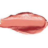 A thick smear of Peony lipstick in pale peach pink, with a smooth glossy centre and raised creamy edges on white.
