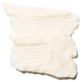 A thick ivory swatch of Burdock and Neem conditioner is spread into overlapping horizontal ridges. Its creamy surface has soft folds and an uneven edge.
