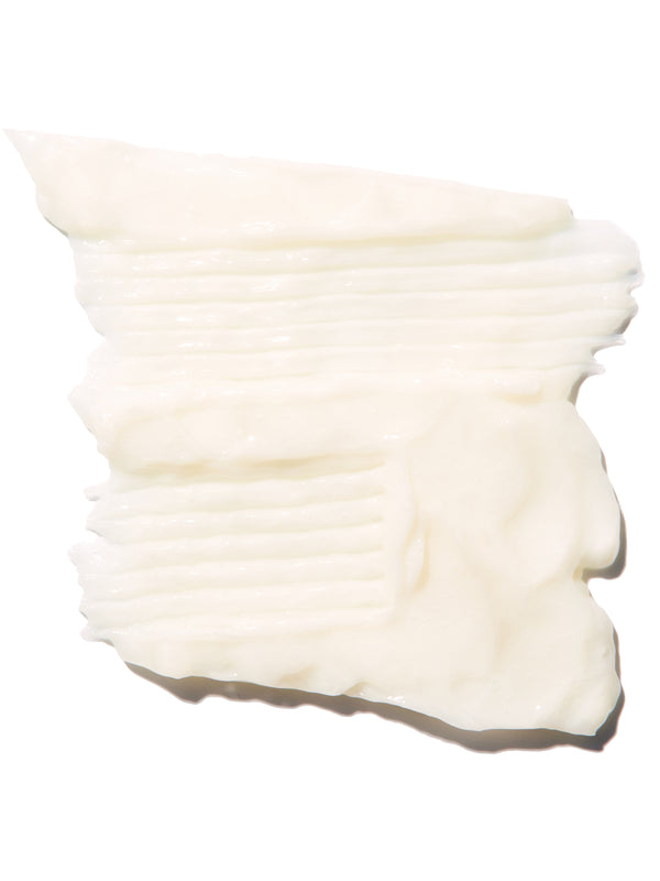 A thick ivory swatch of Burdock and Neem conditioner is spread into overlapping horizontal ridges. Its creamy surface has soft folds and an uneven edge.