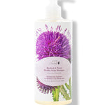 A white pump bottle of 100% Pure Burdock and Neem Healthy Scalp Shampoo has a large purple thistle and green leaves behind a pale pink oval label. Pale yellow liquid is visible at the base.
