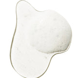 A clear swatch of Burdock and Neem shampoo forms an irregular pool on white. Fine white foam and small bubbles collect across its centre and along one side.