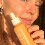 SunButter Nourishing Face Oil held beside face