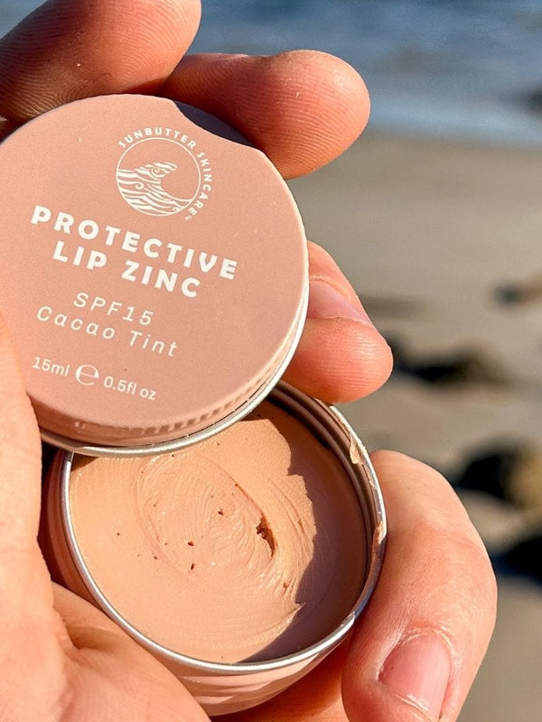 SunButter Cacao Tint Protective Lip Zinc open in hand