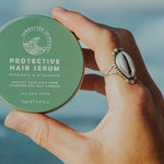 SunButter Protective Hair Serum held in hand