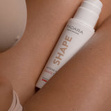 Model applying Madara Shape Caffeine-Mate Cellulite Cream