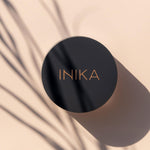 Model applying INIKA Organic Loose Mineral Foundation SPF25 with a brush
