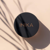 Model applying INIKA Organic Loose Mineral Foundation SPF25 with a brush