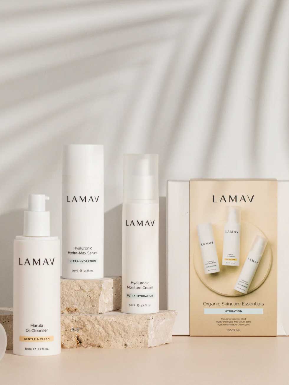 Three LAMAV Hydration Skin Discovery Packs are displayed on stone blocks with soft shadows, highlighting the minimalist white packaging and natural aesthetic.
