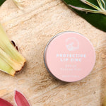 SunButter Protea Tint Protective Lip Zinc styled with flowers