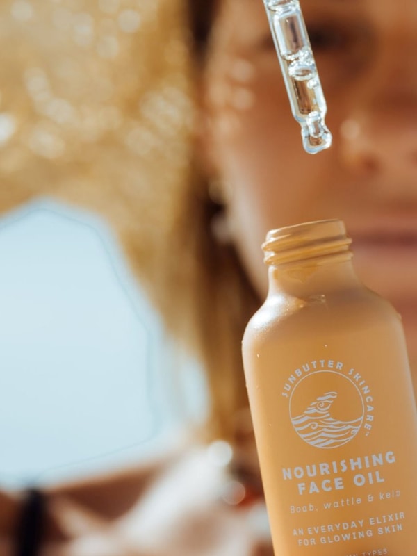 SunButter Nourishing Face Oil being applied