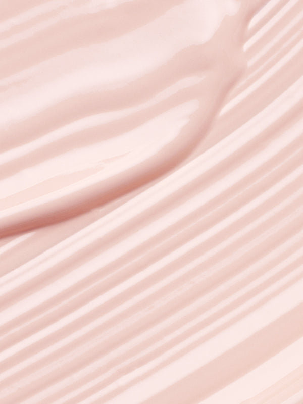 Close-up of pale pink Kakadu Plum Vitamin C Eye Cream spread into smooth diagonal ridges and glossy folds.