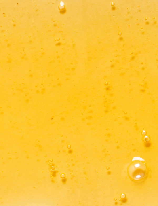 Golden oil texture of KORA Organics Noni Glow Body Oil