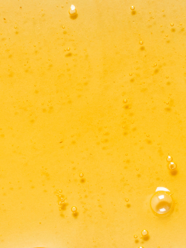 Golden oil texture of KORA Organics Noni Glow Body Oil