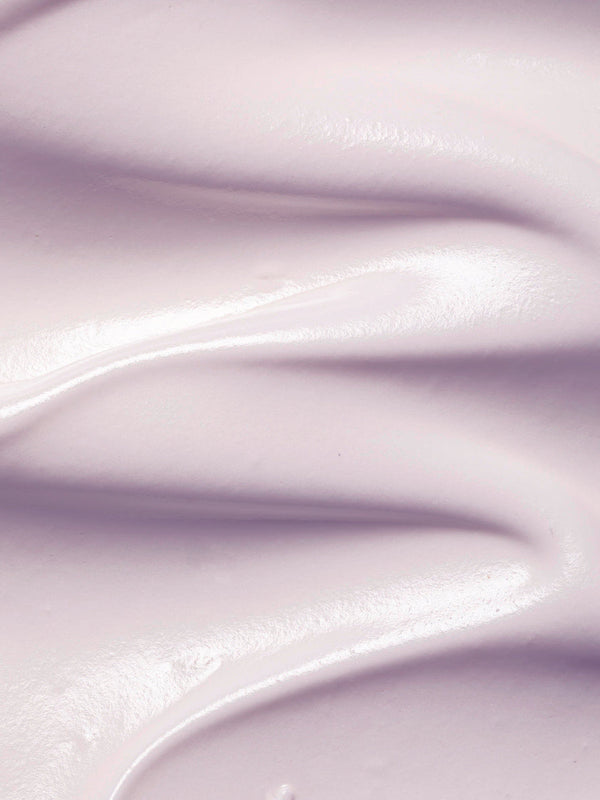 Close-up of pale lilac Plant Stem Cell Retinol Alternative Moisturiser spread into thick, smooth waves with glossy ridges.