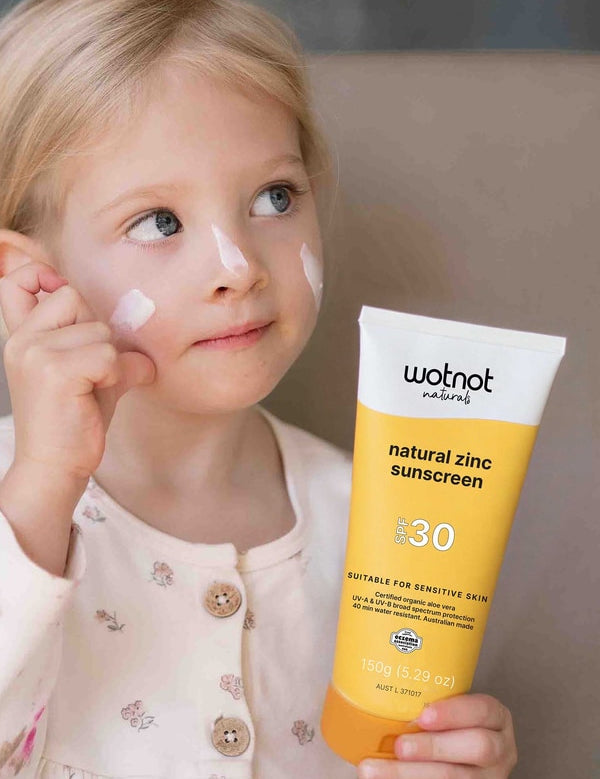 Child applying Wotnot Natural Family Sunscreen SPF 30