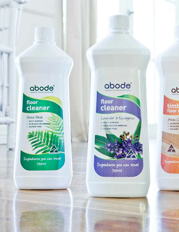 Set of three Abode floor cleaners including Lavender and Eucalyptus standing on a timber floor