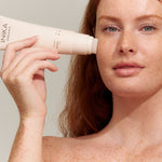 Model applying INIKA Organic Phytofuse Renew Cream Cleanser to her face