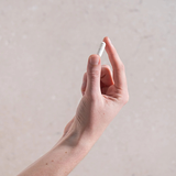 Hand holding a Herbs of Gold Magnesium Citrate 900 capsule
