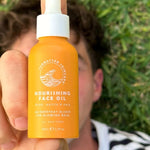 SunButter Nourishing Face Oil held outdoors