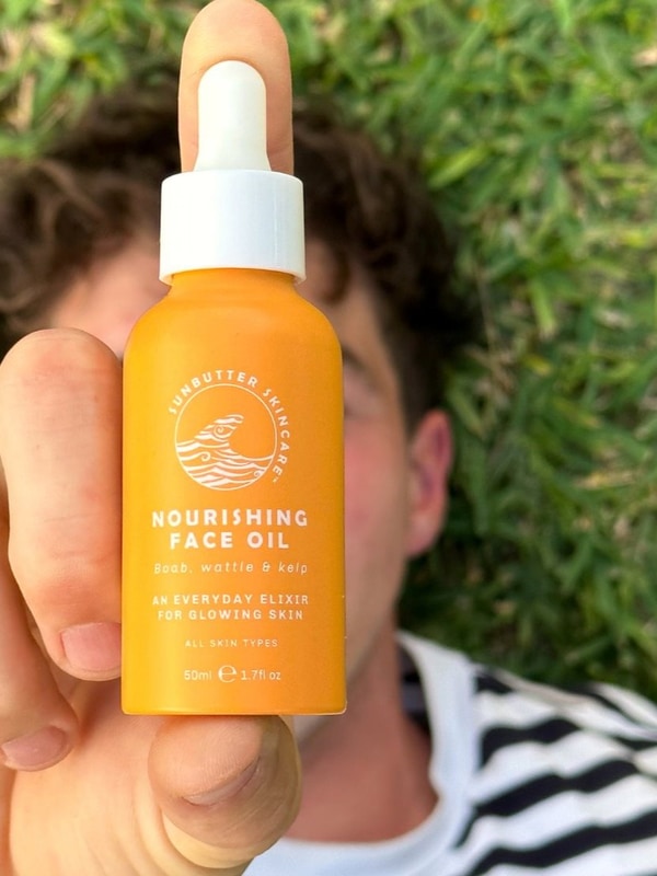 SunButter Nourishing Face Oil held outdoors