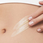 Model smoothing KORA Organics Nourishing Hand and Body Lotion onto her skin