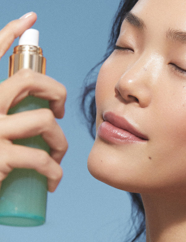 Model spraying KORA Organics Minty Mineral Hydration Mist on her face