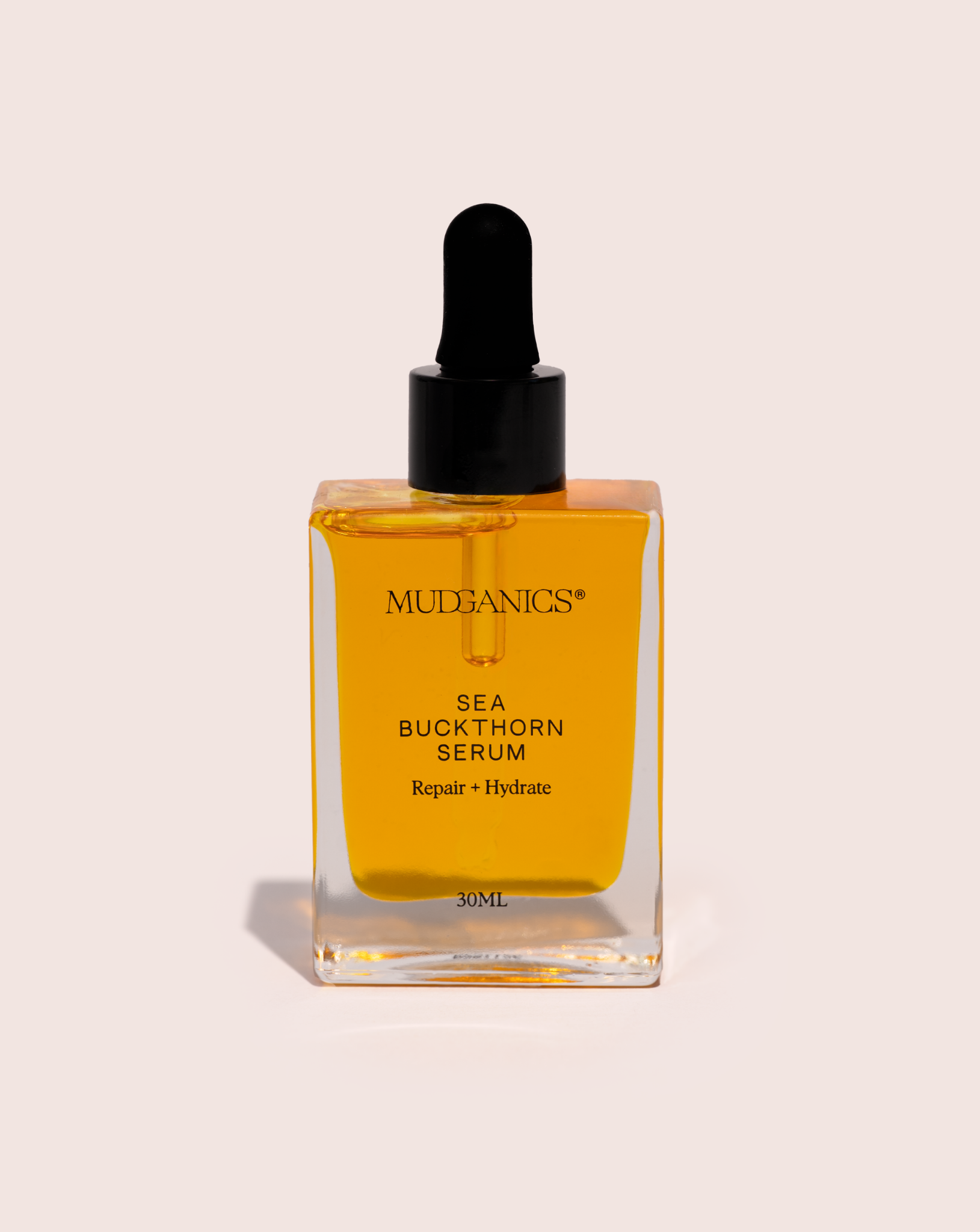 Mud Organics Sea Buckthorn Serum 30ml on a soft blush background