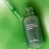 Ere Perez Quandong Green Booster Serum pouring from an open green glass bottle with the dropper alongside
