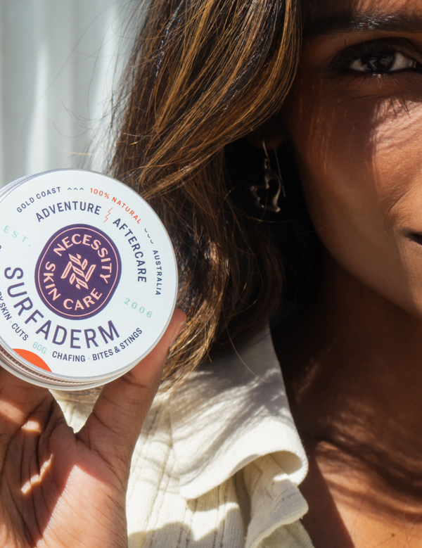 Woman holding Necessity Surfaderm