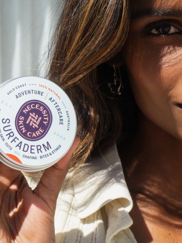 Woman holding Necessity Surfaderm