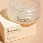 Ere Perez Fig All-Beauty Jelly open jar resting on its box against a peach background