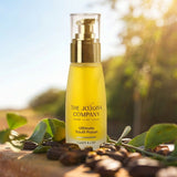 The Jojoba Company Ultimate Youth Potion bottle on a wooden surface with greenery behind