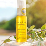 The Jojoba Company Calming Jojoba bottle standing on a stone surface