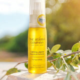 The Jojoba Company Calming Jojoba bottle standing on a stone surface