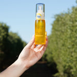 Hand holding a bottle of The Jojoba Company Calming Jojoba