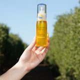 Hand holding a bottle of The Jojoba Company Calming Jojoba