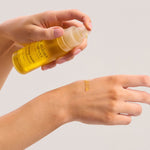 Dispensing The Jojoba Company Calming Jojoba onto the back of the hand