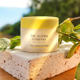 The Jojoba Company Pure Jojoba Gel Mask jar on a stone surface with greenery