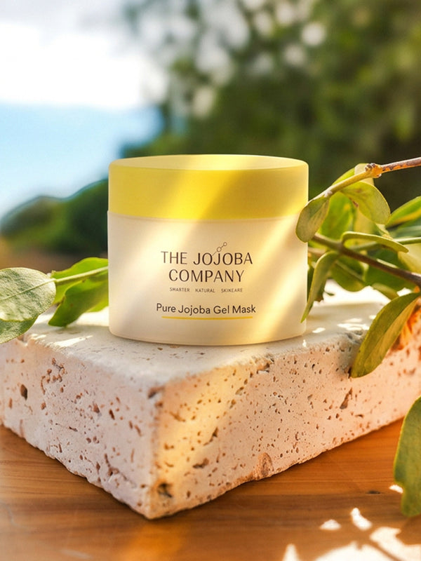 The Jojoba Company Pure Jojoba Gel Mask jar on a stone surface with greenery