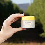 Hand holding a jar of The Jojoba Company Pure Jojoba Gel Mask