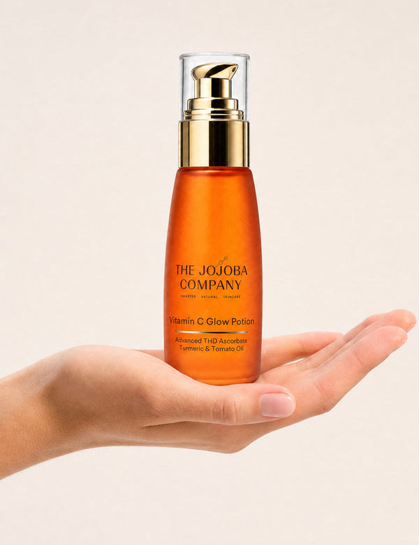 Open hand holding a bottle of The Jojoba Company Vitamin C Glow Potion