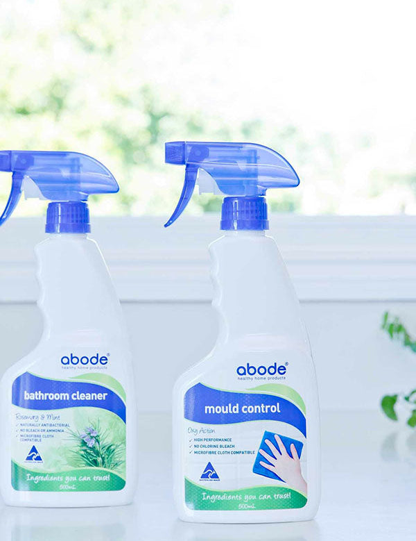 Abode Bathroom Cleaner and Mould Control spray bottles on a windowsill in natural light