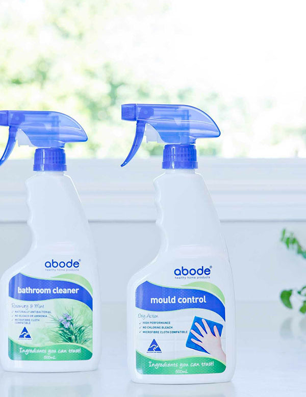 Abode Oxy Action Mould Control Spray beside the Bathroom Cleaner on a windowsill in natural light
