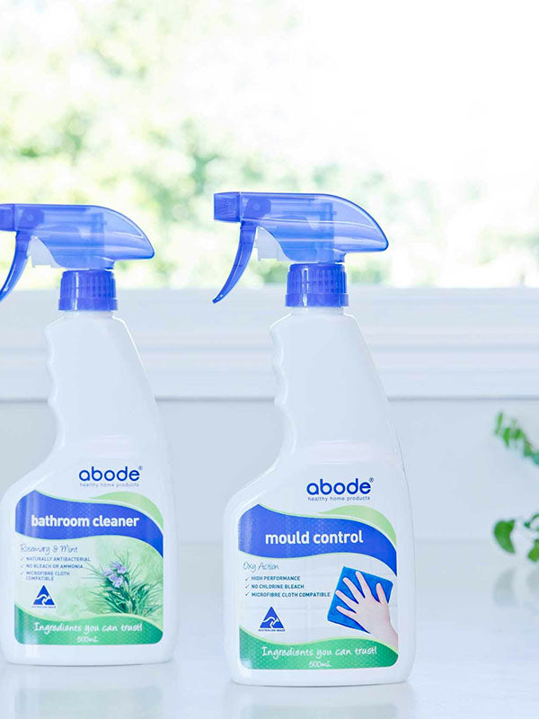 Abode Oxy Action Mould Control Spray beside the Bathroom Cleaner on a windowsill in natural light