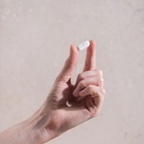 Hand holding a Herbs of Gold Magnesium Forte tablet